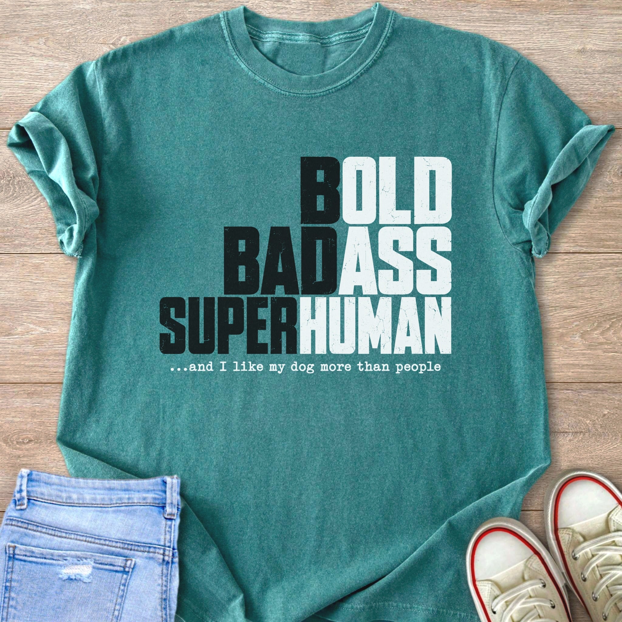 Teal t-shirt with bold, badass, superhuman text and dog quote.