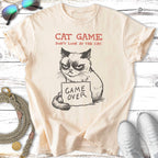 Cream t-shirt with grumpy cat holding "Game Over" sign.
