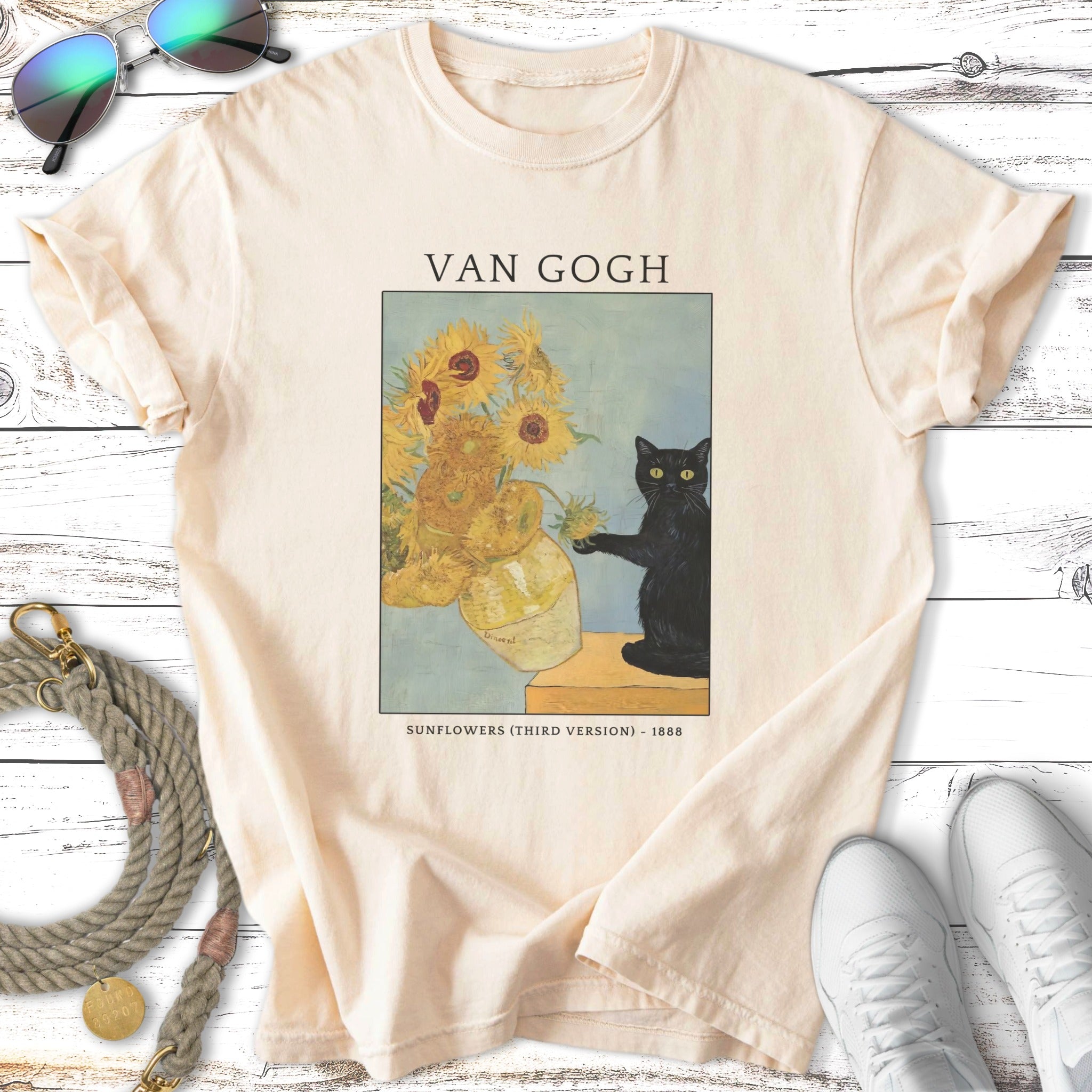Van Gogh's Sunflowers painting on a cream t-shirt with a black cat.