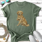 Golden Retriever wearing an "I LOVE MOM" heart tattoo sits on a green t-shirt.