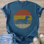 Dachshund silhouette on a vintage faded sunset graphic t-shirt.