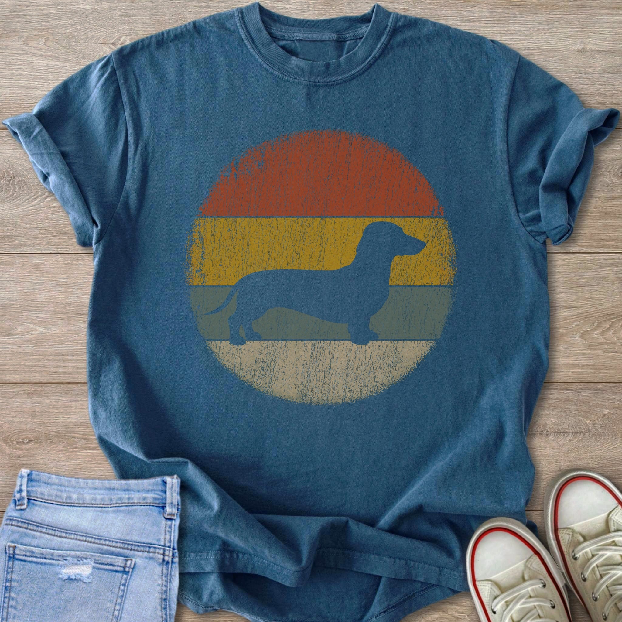 Dachshund silhouette on a vintage faded sunset graphic t-shirt.