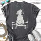 White dog playing drums on a dark gray t-shirt.