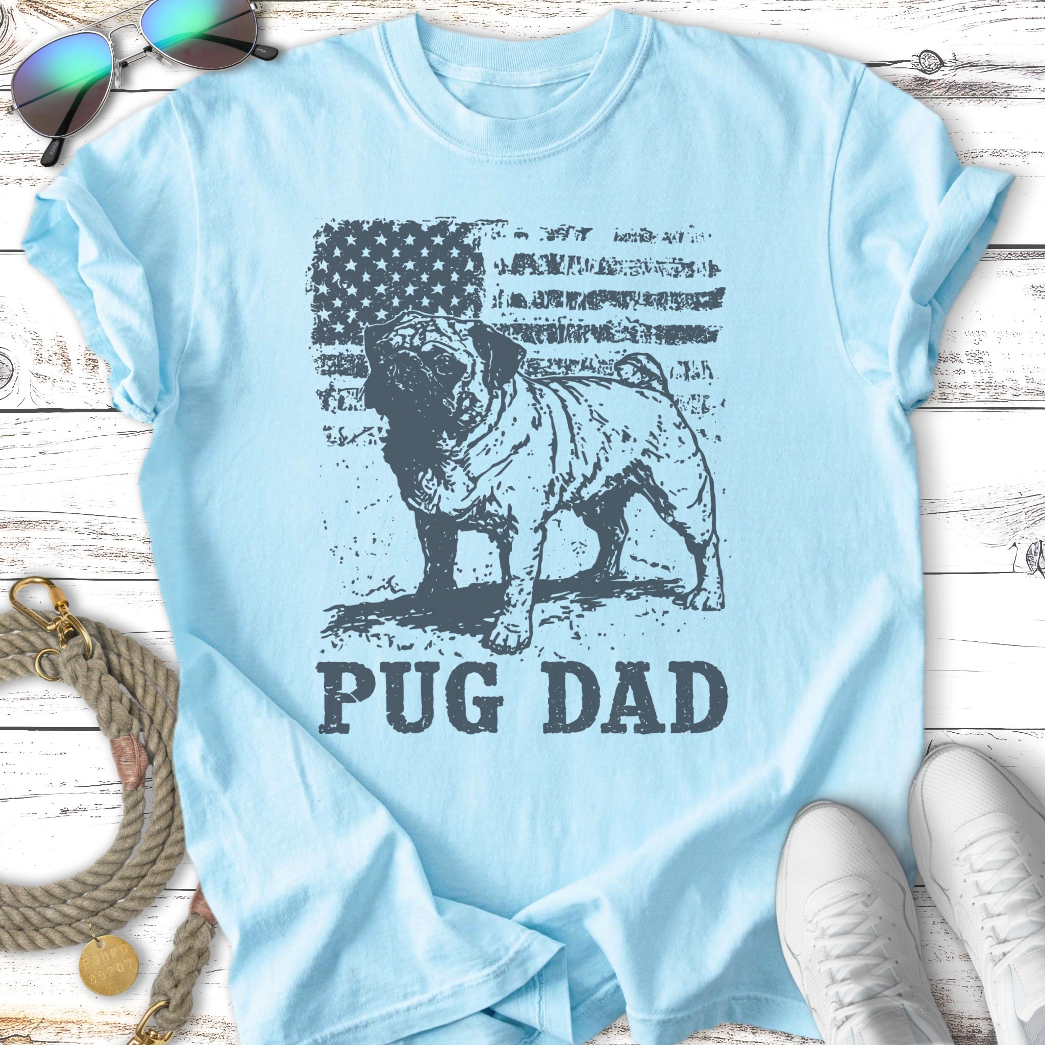 Light blue t-shirt with a distressed American flag and a pug, text reads "PUG DAD".