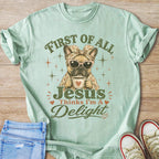 French bulldog wearing bandana and sunglasses holds coffee mug. Text reads "First of all Jesus Thinks I'm A Delight".