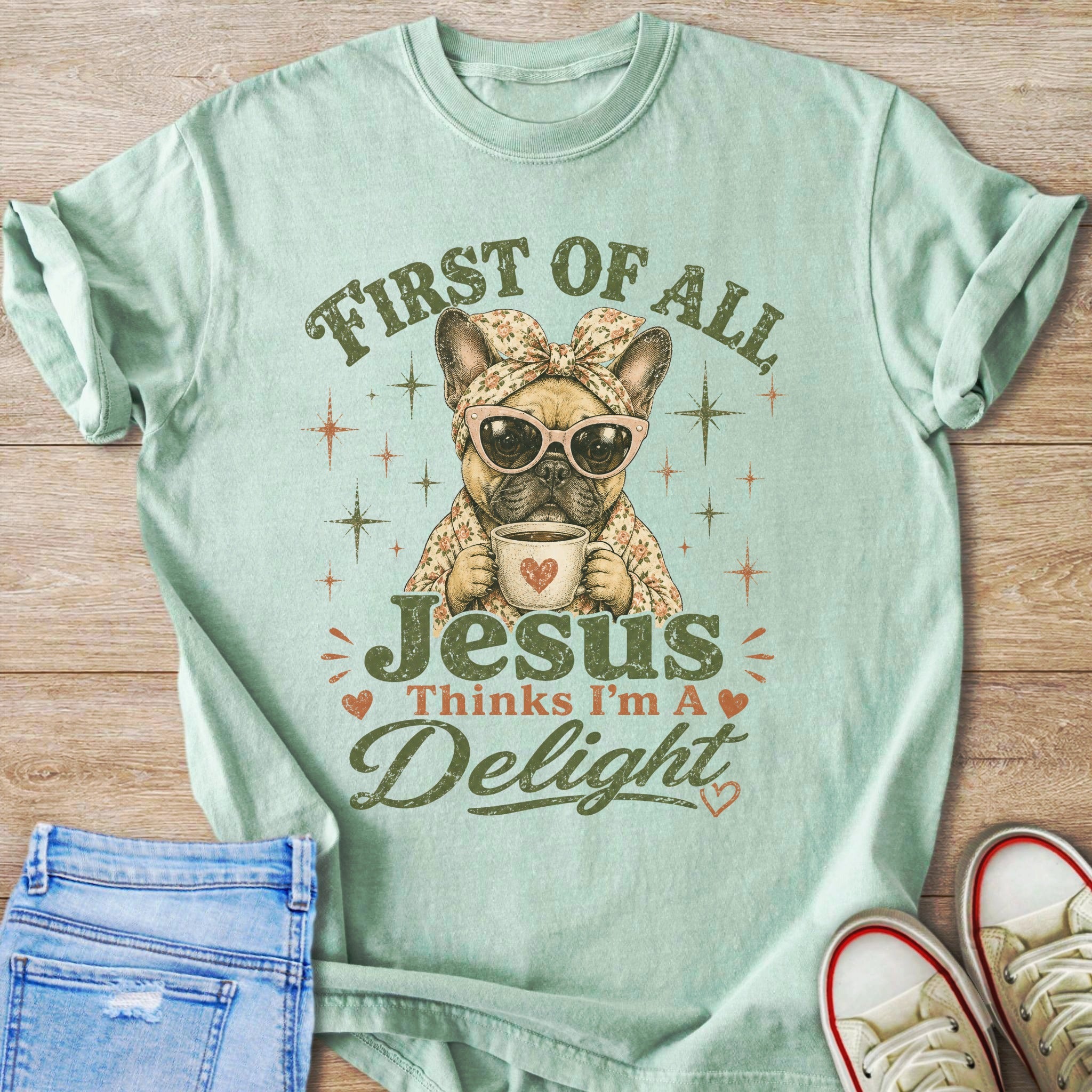 French bulldog wearing bandana and sunglasses holds coffee mug. Text reads "First of all Jesus Thinks I'm A Delight".