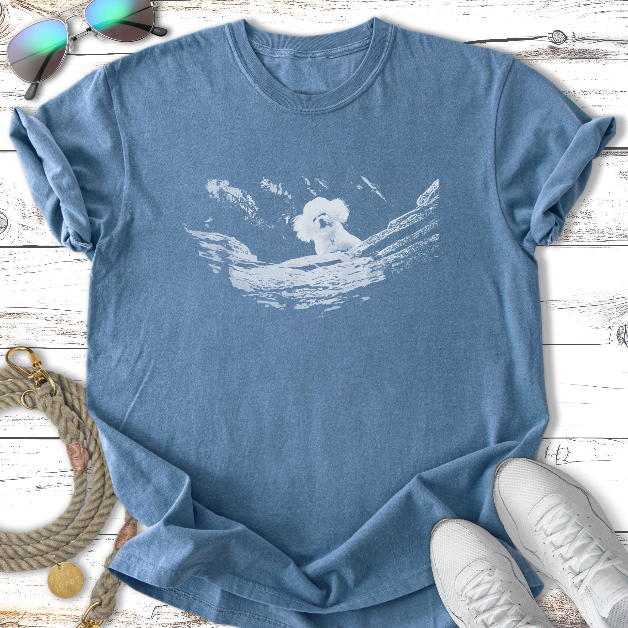 Blue t-shirt with a white koala graphic on a branch.