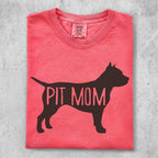 Coral t-shirt with a black pit bull silhouette and "PIT MOM" text.