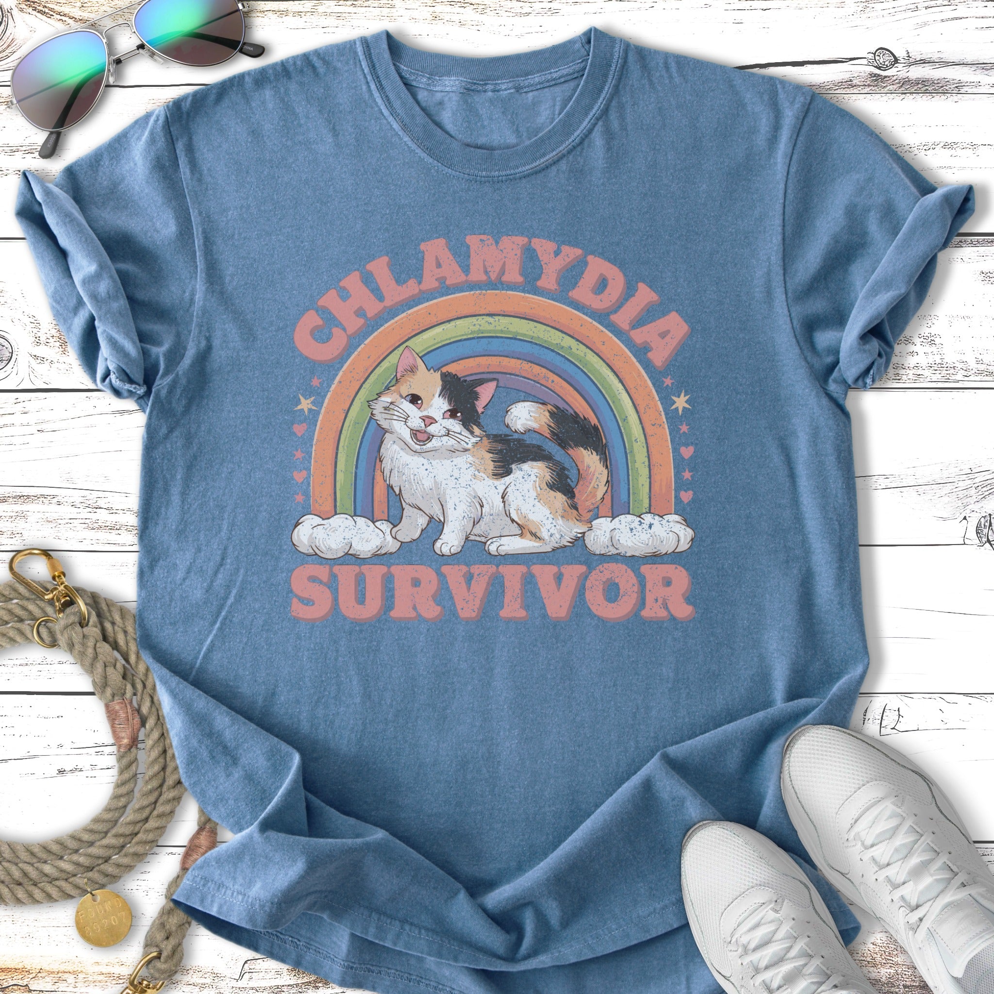 Blue t-shirt with cat graphic and "Chlamydia Survivor" text.