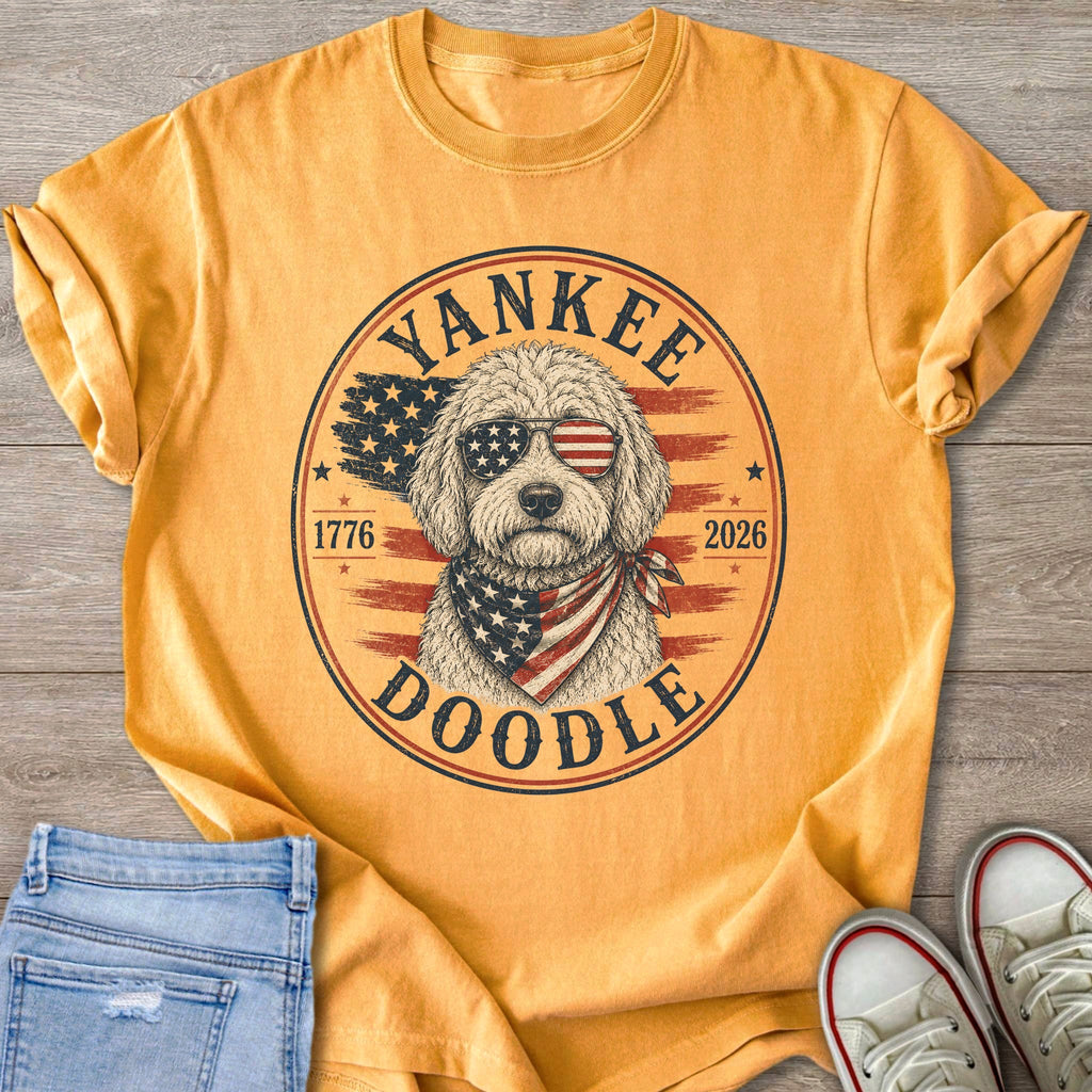 Gold t-shirt with a Doodle dog wearing patriotic sunglasses and bandana.