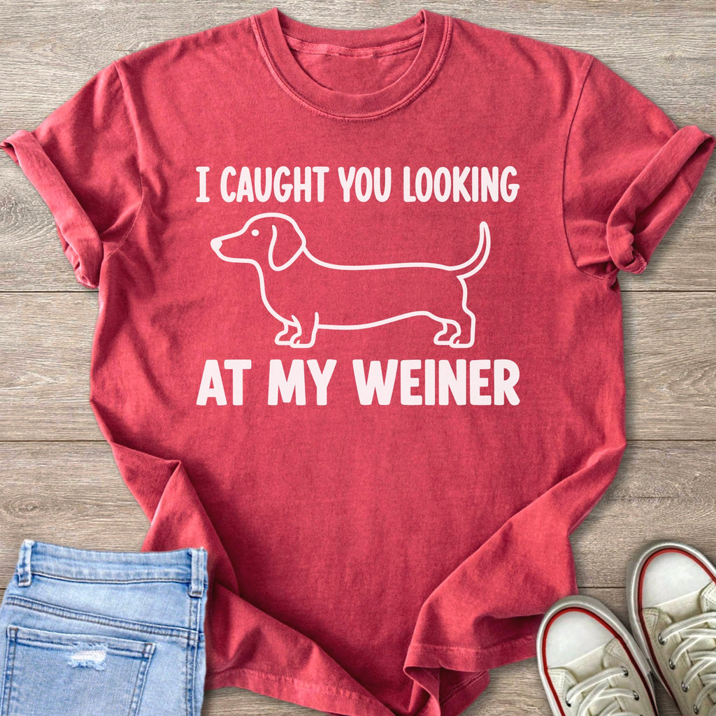 Red t-shirt with white graphic of dachshund and text "I CAUGHT YOU LOOKING AT MY WEINER".