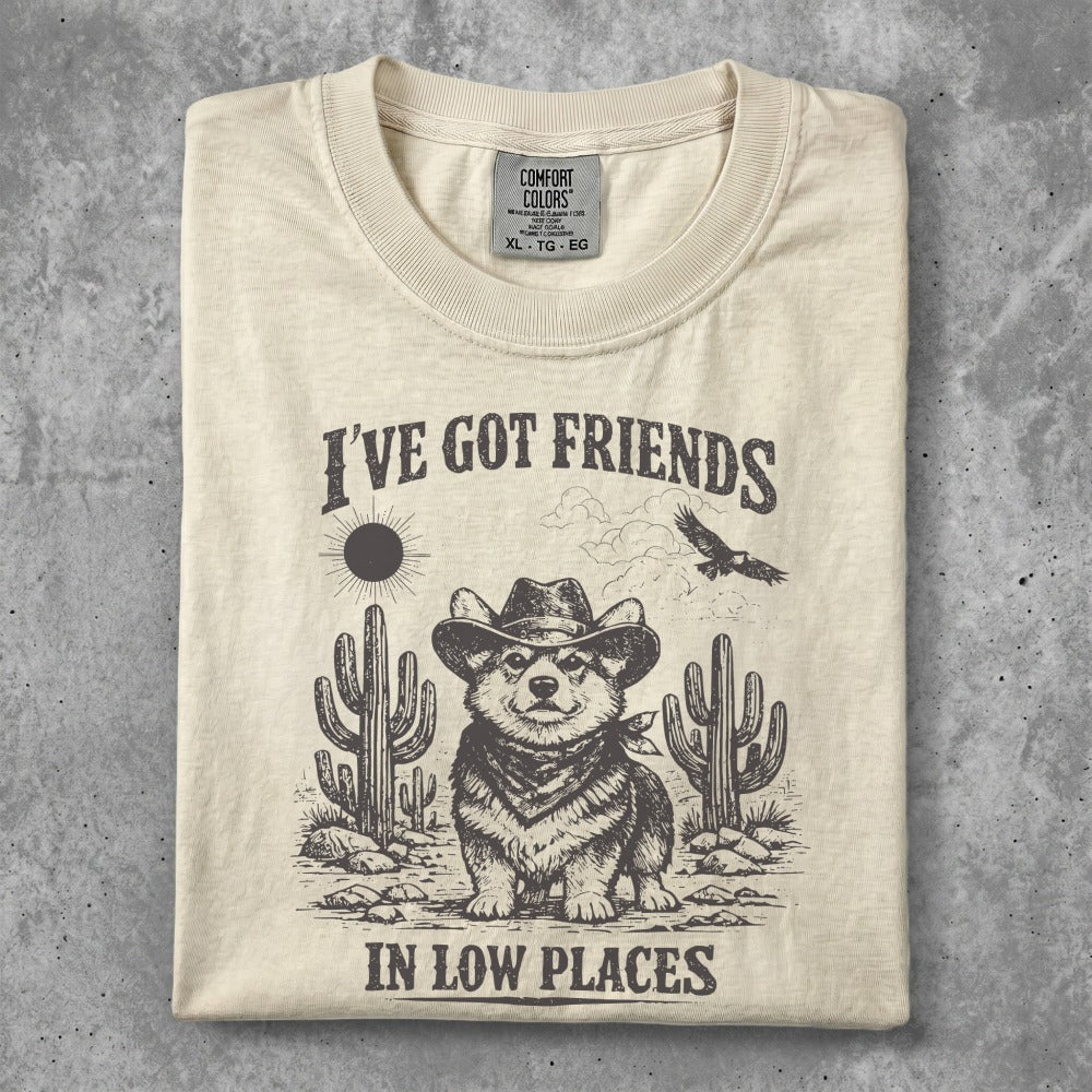 Cream t-shirt with "I've Got Friends in Low Places" text and cowboy corgi graphic.