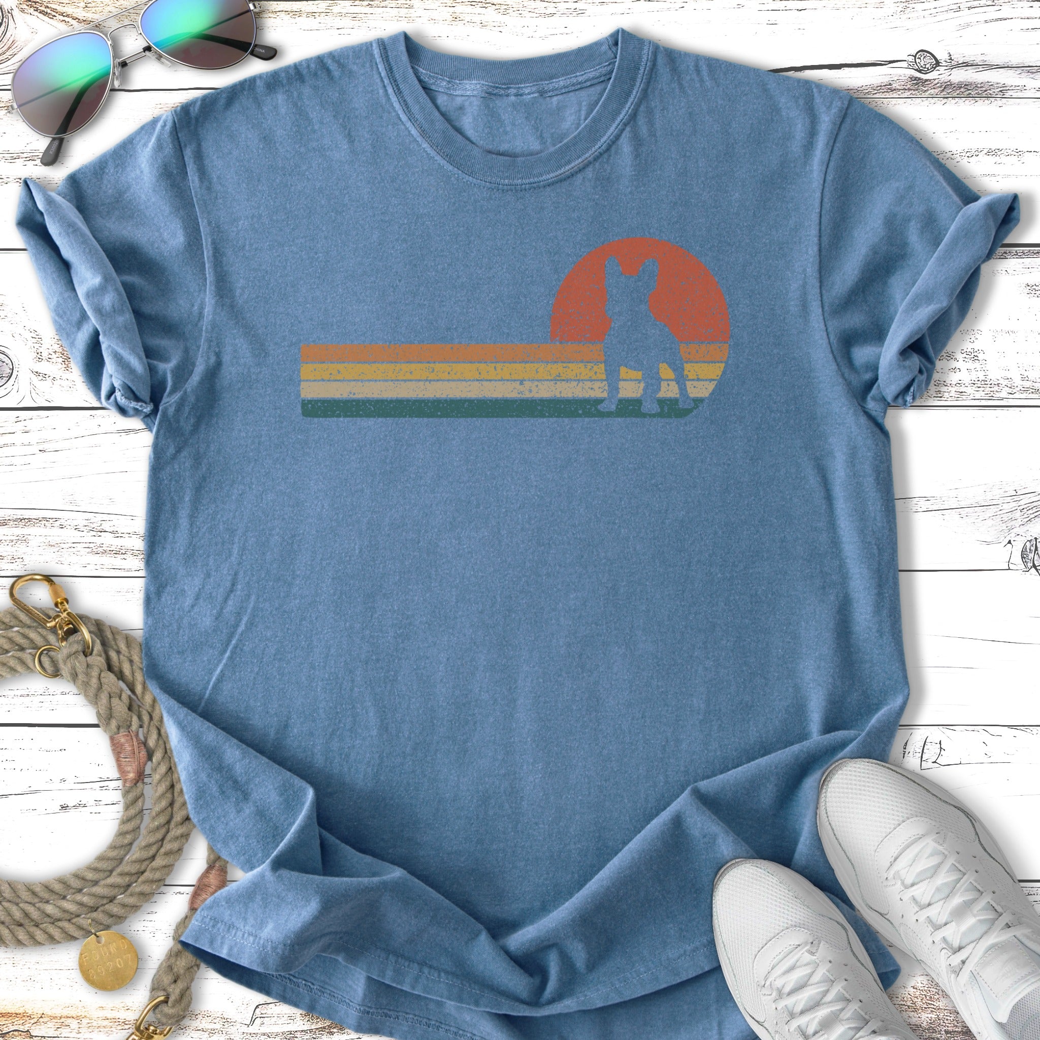 Blue t-shirt with retro sunset design featuring a dog silhouette.