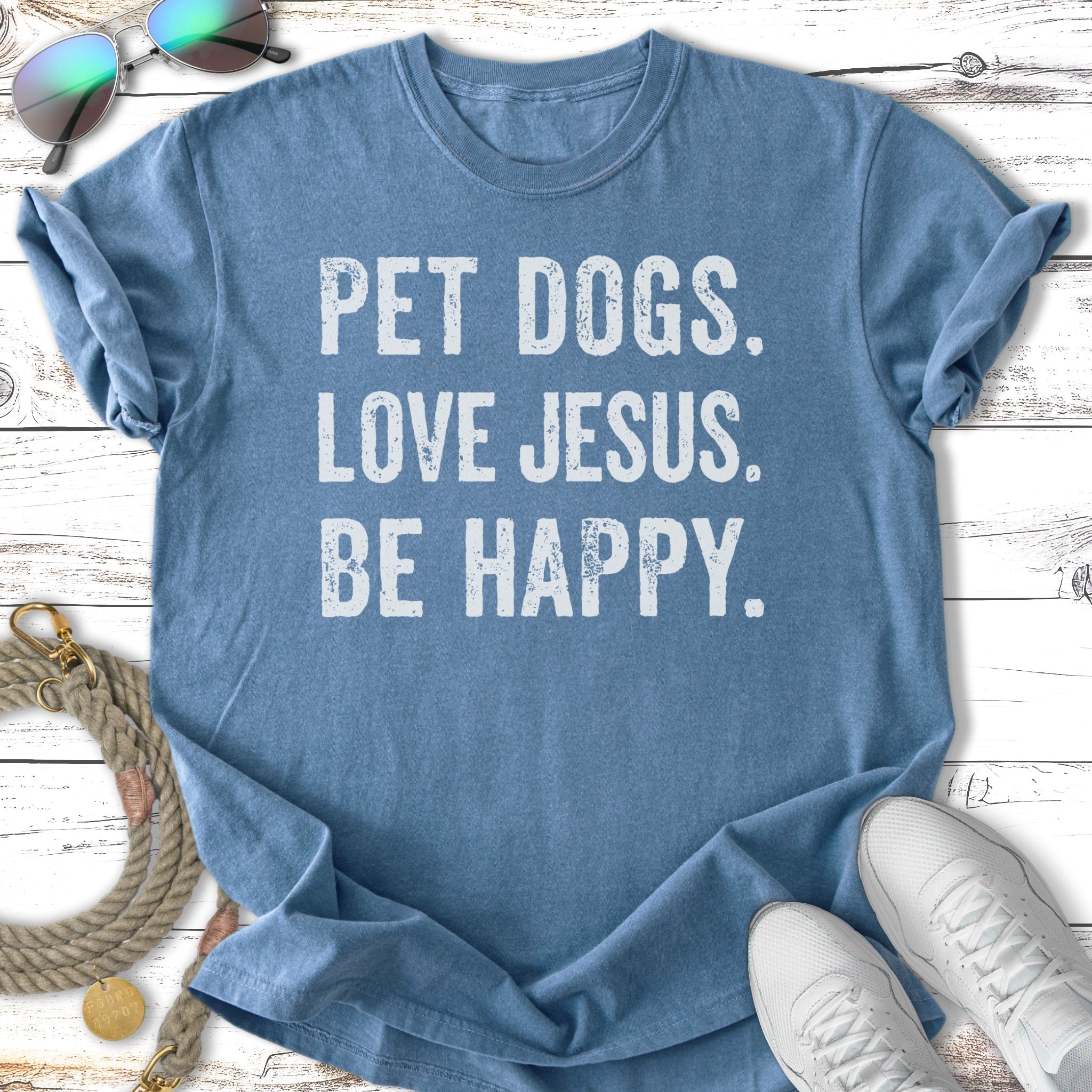 Blue t-shirt with "PET DOGS. LOVE JESUS. BE HAPPY." text.