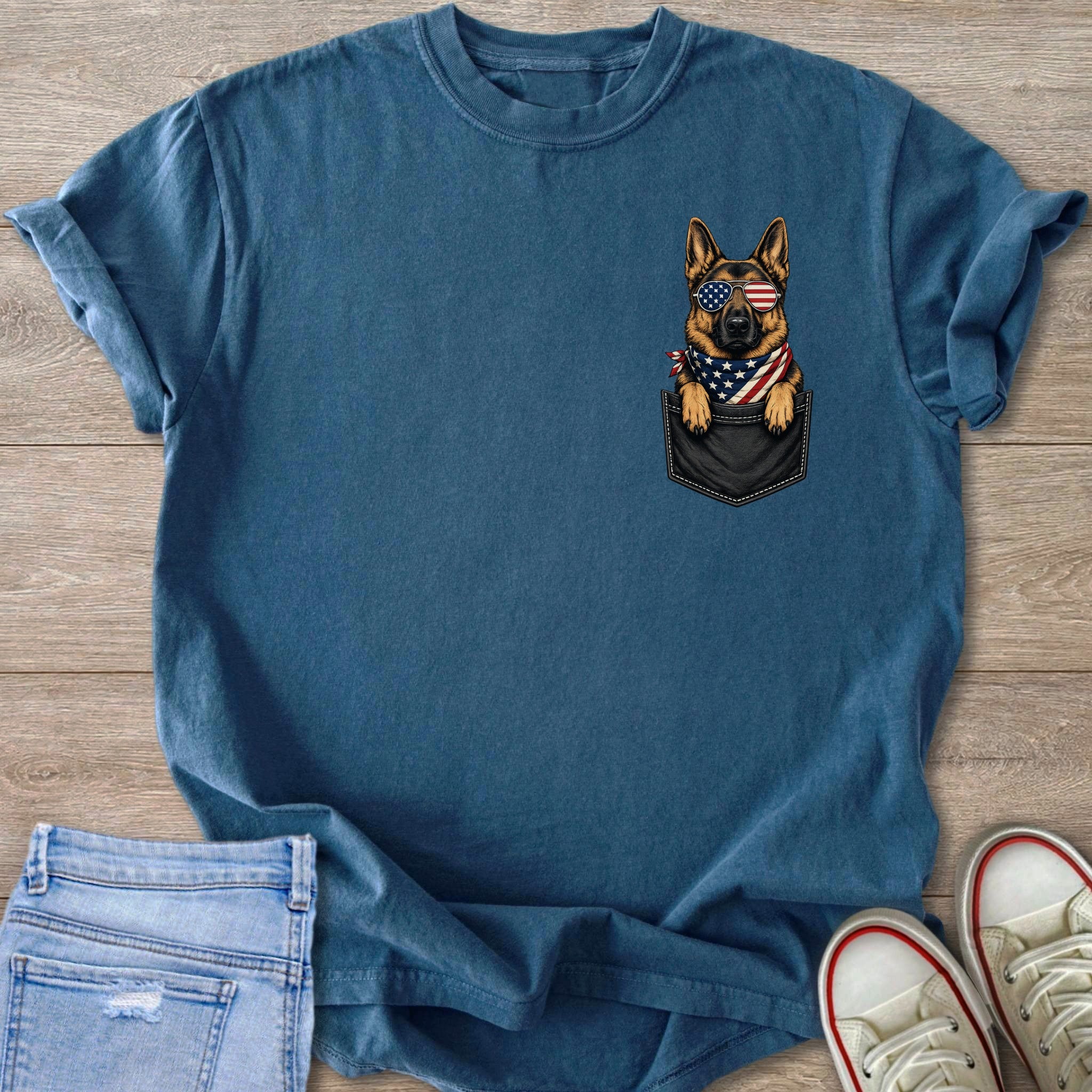 German Shepherd wearing patriotic sunglasses and bandana peeking from a pocket.