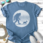 Bigfoot walking a Boston Terrier on a leash, depicted in a circle.