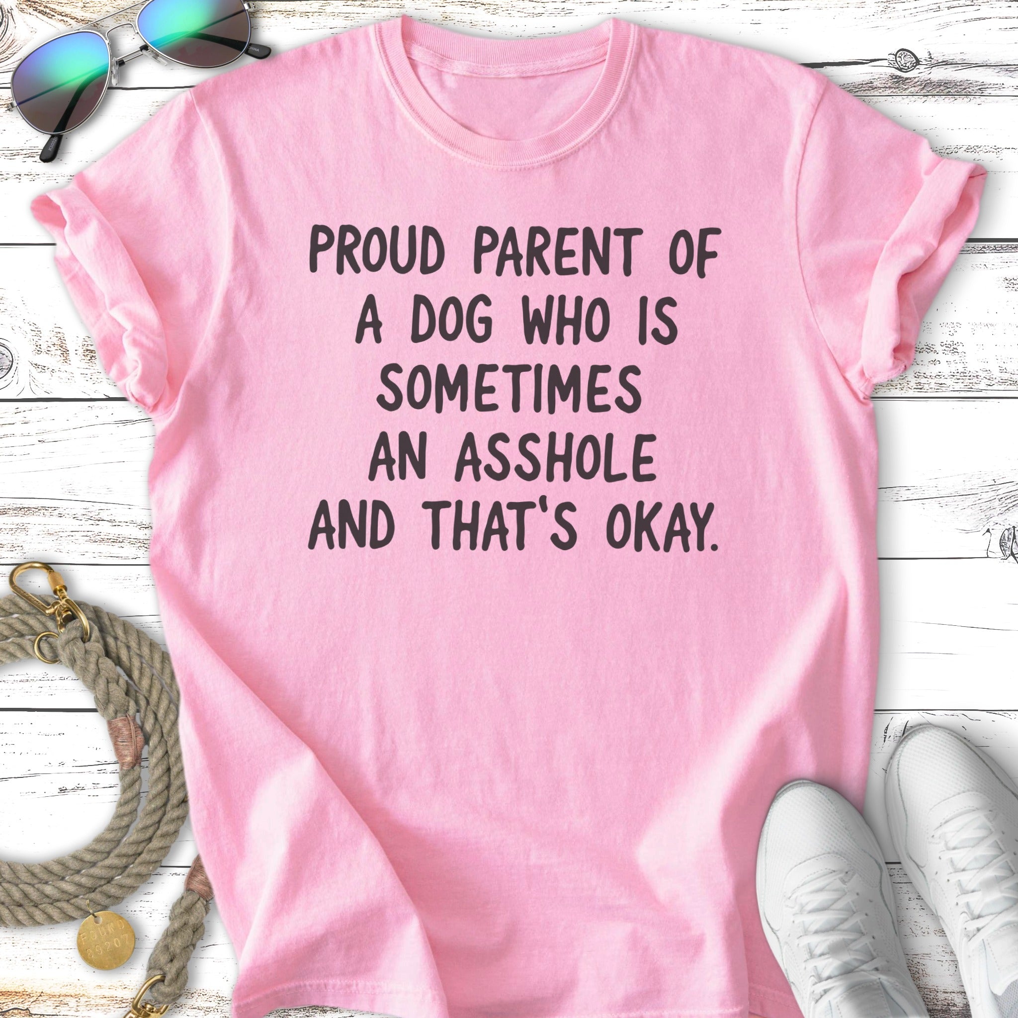 Pink t-shirt with text "Proud parent of a dog who is sometimes an asshole and that's okay."