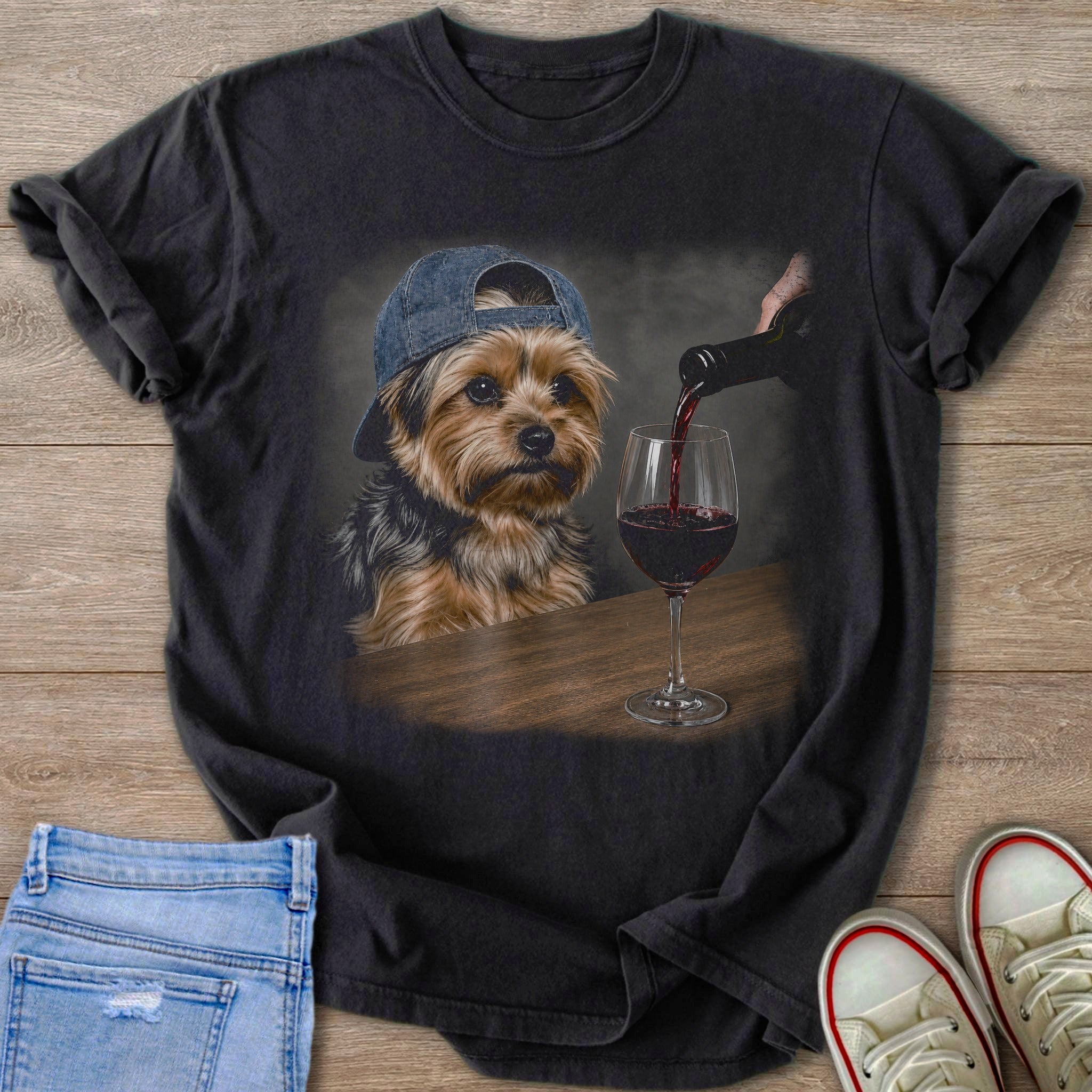 Yorkshire terrier wearing a blue baseball cap, watching red wine being poured into a glass.
