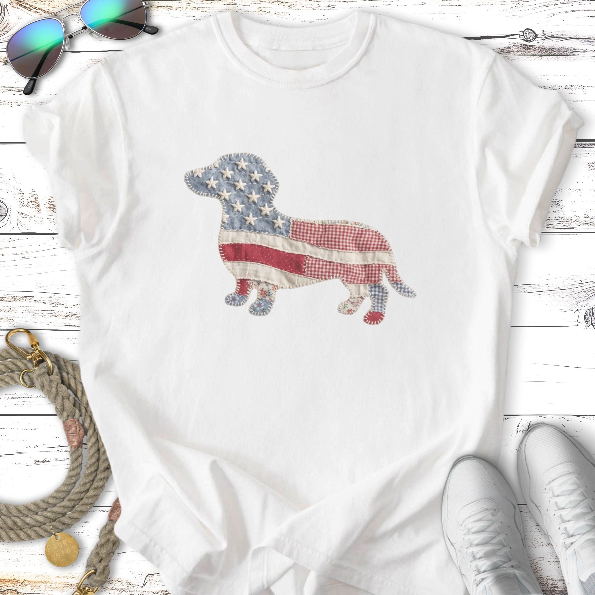 Dachshund silhouette filled with American flag fabric patterns on a white t-shirt.
