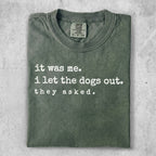 Green t-shirt with "it was me. i let the dogs out. they asked." text.