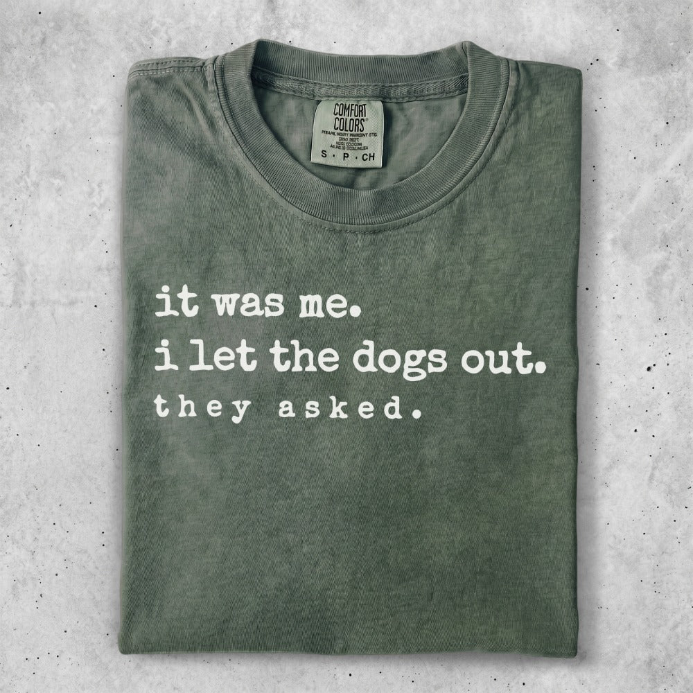 Green t-shirt with "it was me. i let the dogs out. they asked." text.