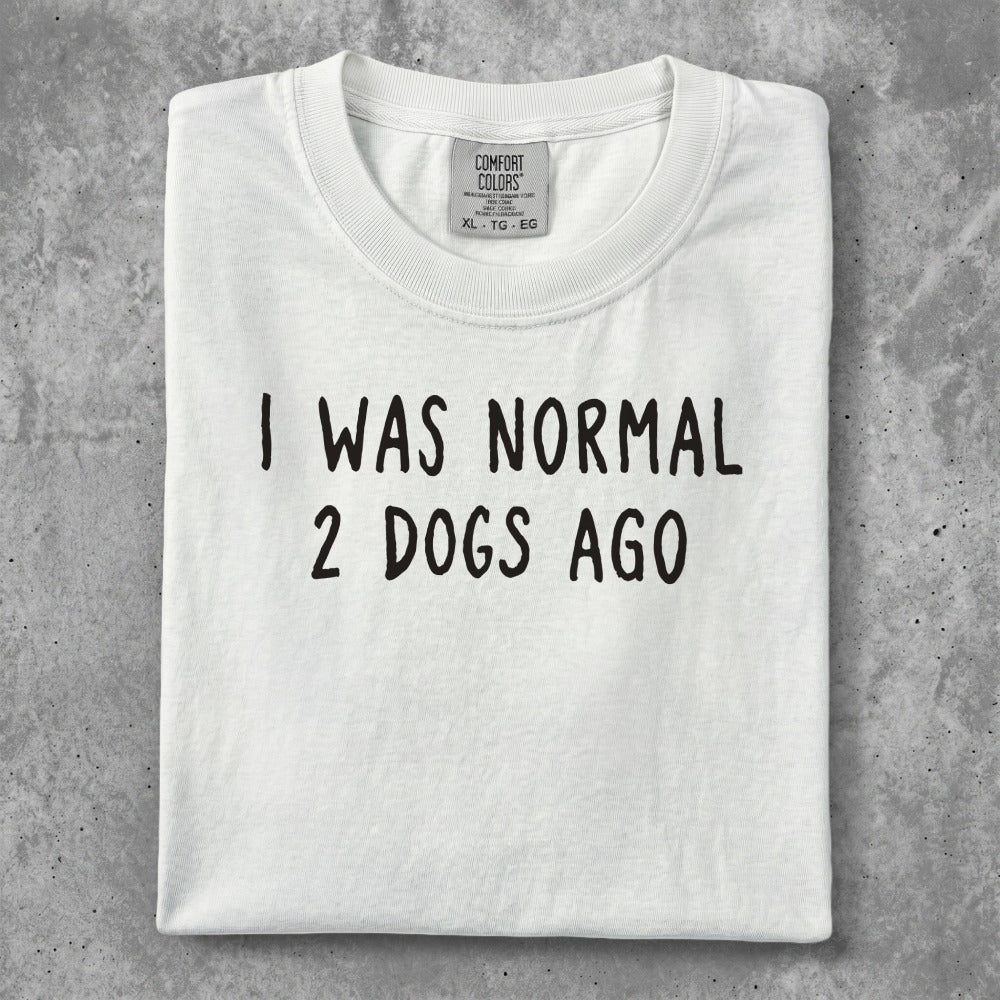 White t-shirt with "I WAS NORMAL 2 DOGS AGO" text.