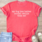 Coral t-shirt with white text "my dog has better social skills than me."