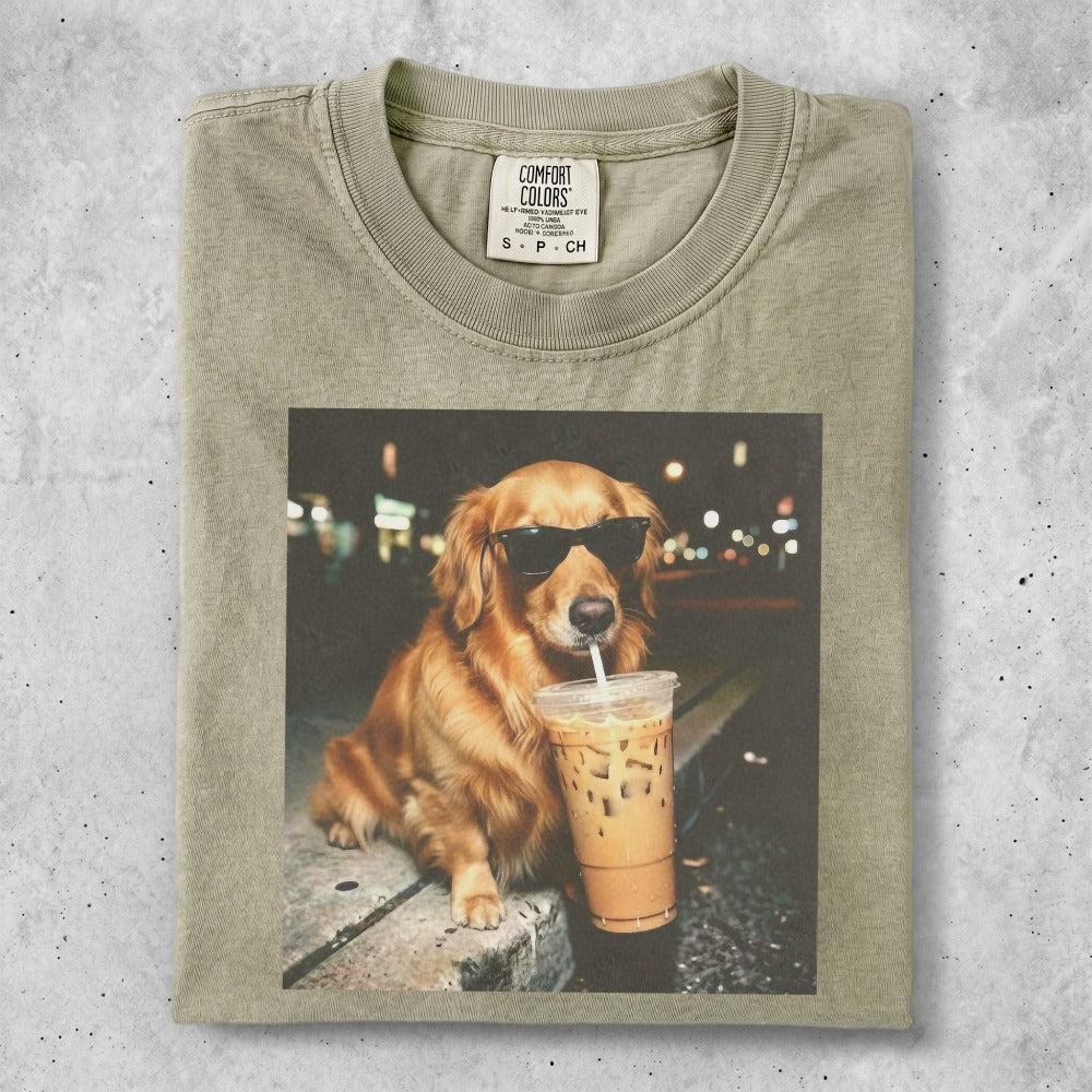 Golden retriever wearing sunglasses drinks from a iced coffee cup.