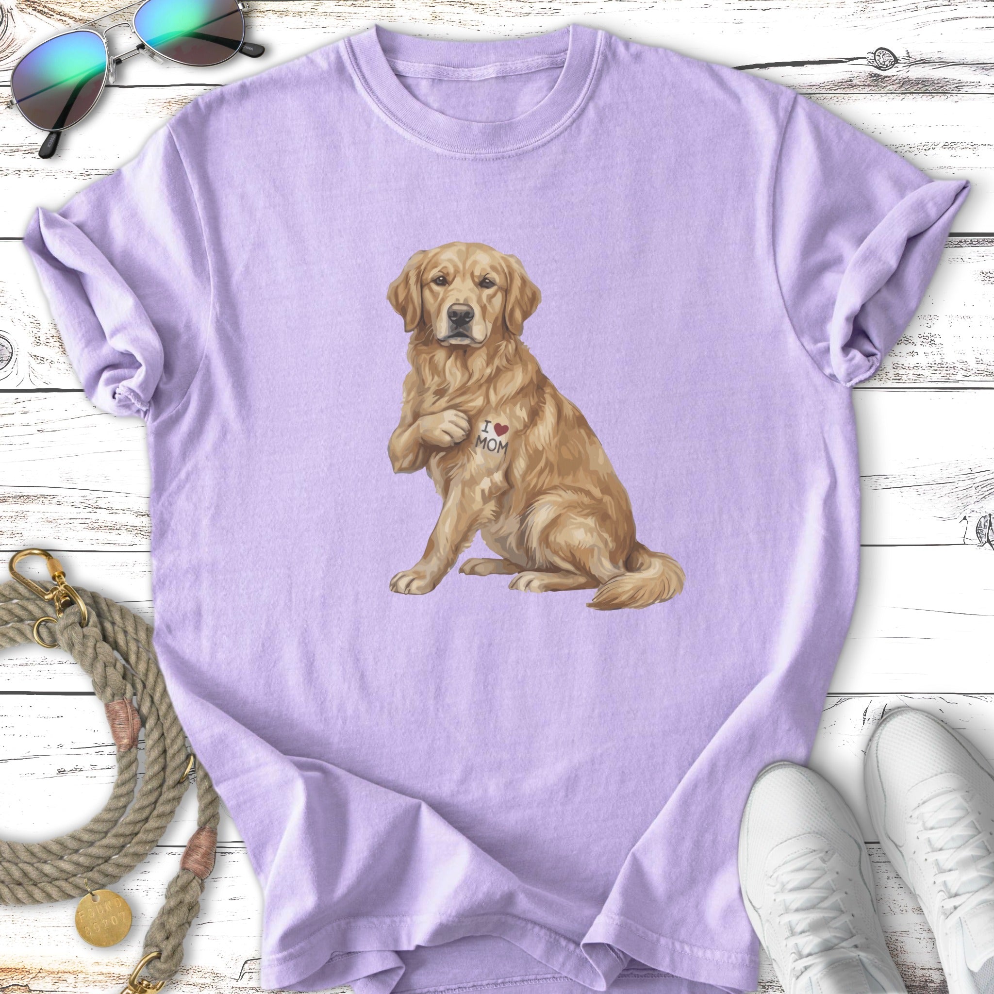 Golden Retriever dog with "I ❤️ MOM" tattoo on purple t-shirt.