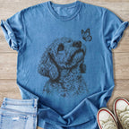 Blue t-shirt with a black line drawing of a dog looking at a butterfly.