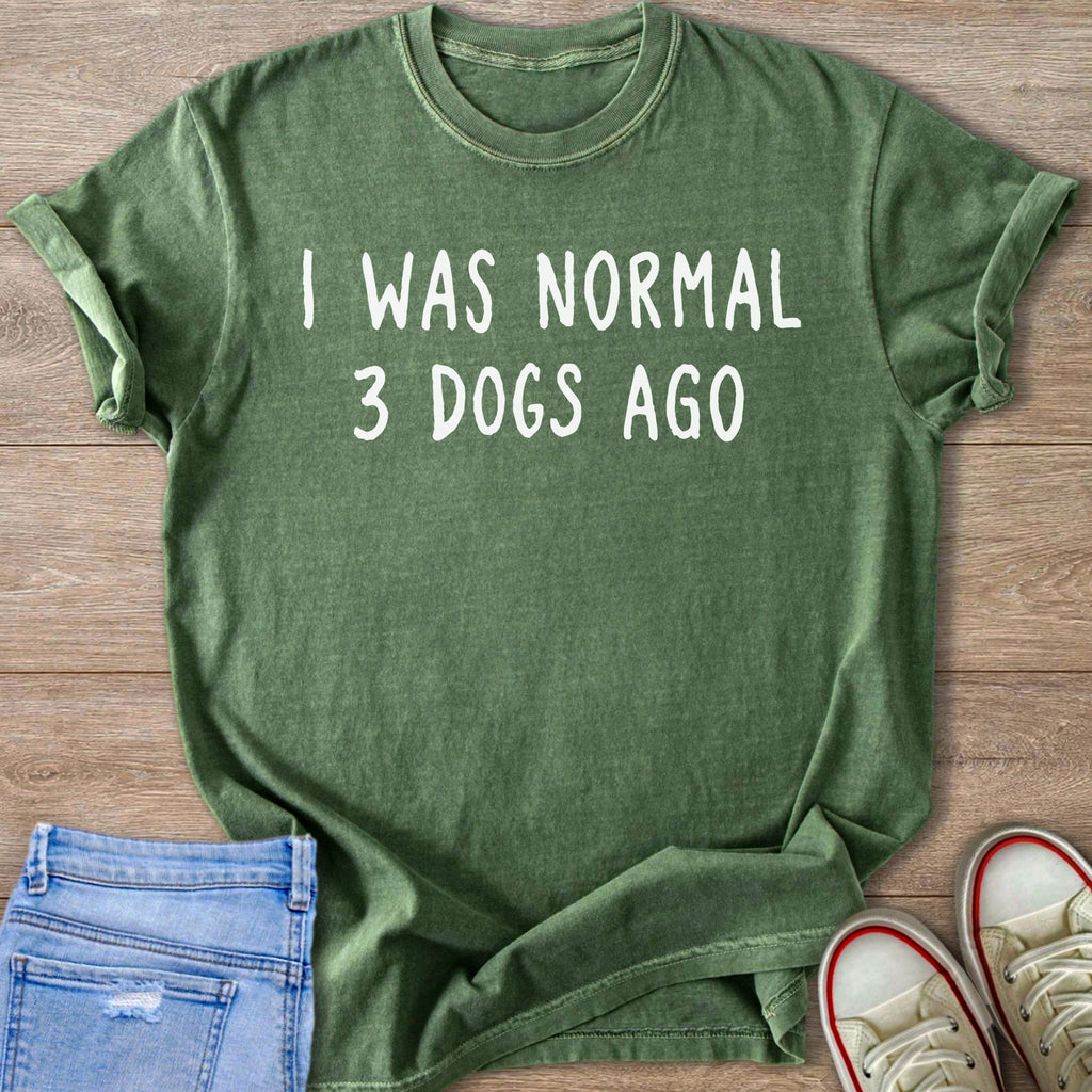 Green t-shirt with white text reading "I WAS NORMAL 3 DOGS AGO".