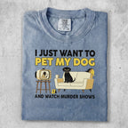T-shirt with graphic of dog on couch watching TV and text "I just want to pet my dog and watch murder shows".