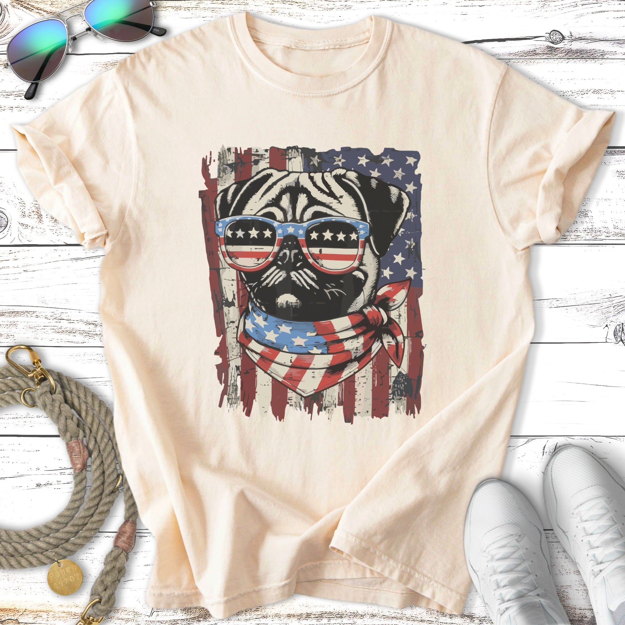 Pug wearing sunglasses and bandana with American flag design.