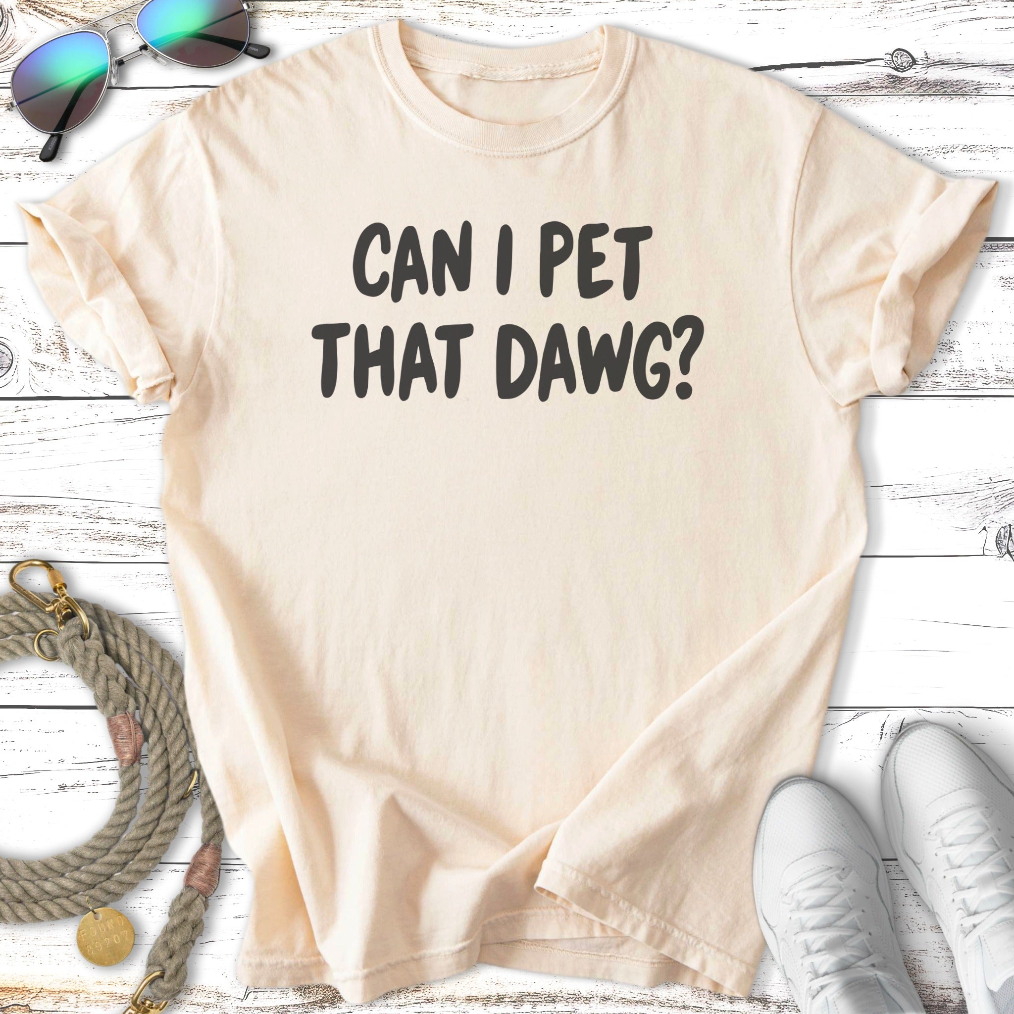 Cream t-shirt with "CAN I PET THAT DAWG?" text.