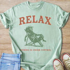 Mint t-shirt with text "RELAX" and dog in lounge chair.
