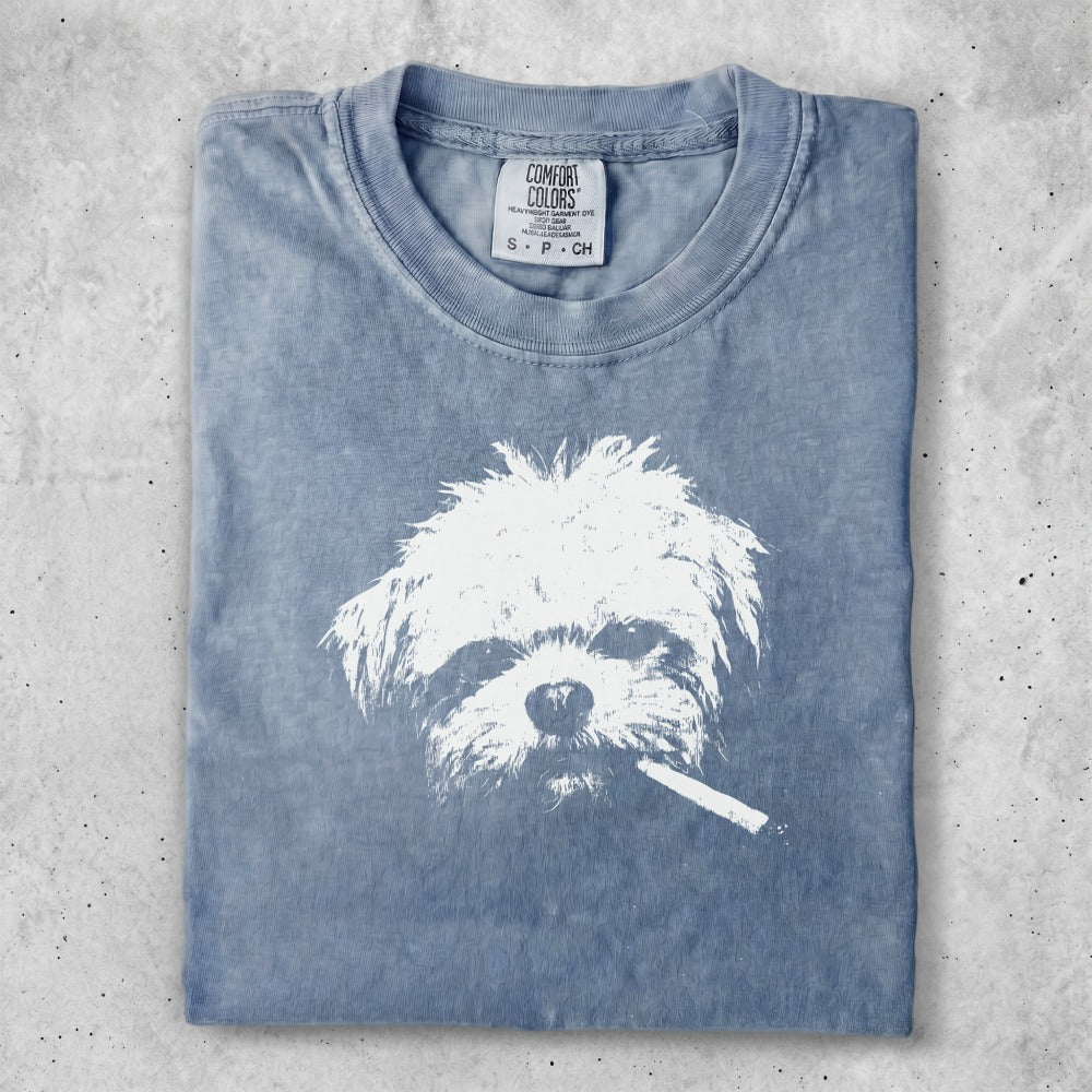 Blue t-shirt with white dog graphic smoking a cigarette.