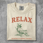 T-shirt with a wolf in a chair and "RELAX NOTHING IS UNDER CONTROL" text.