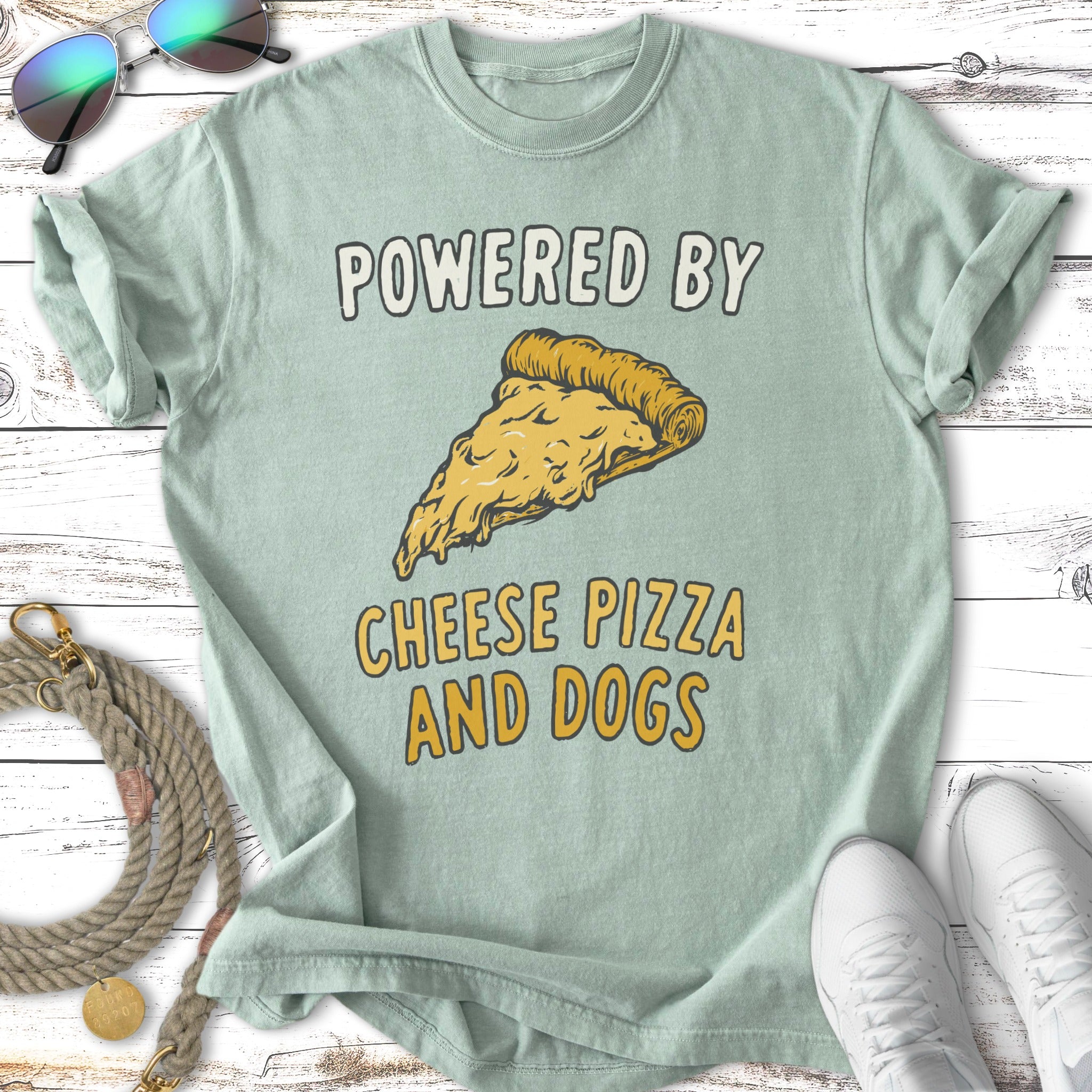 T-shirt with "Powered by Cheese Pizza and Dogs" text and a slice of pizza.