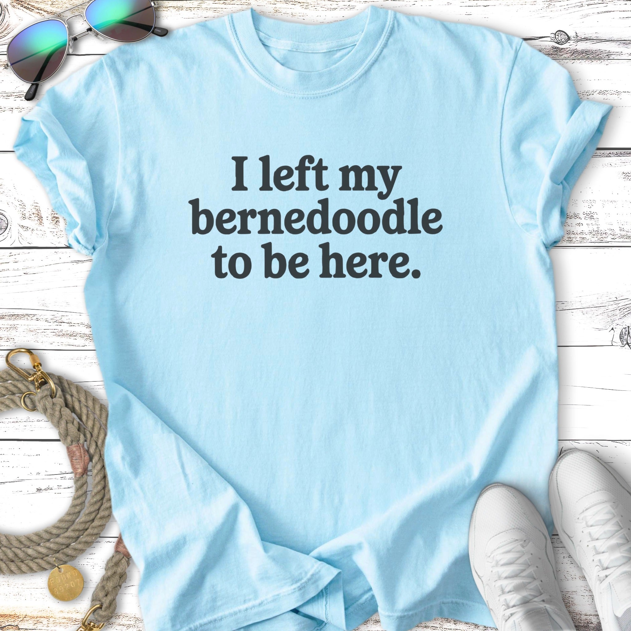Light blue t-shirt with "I left my Bernedoodle to be here." text.