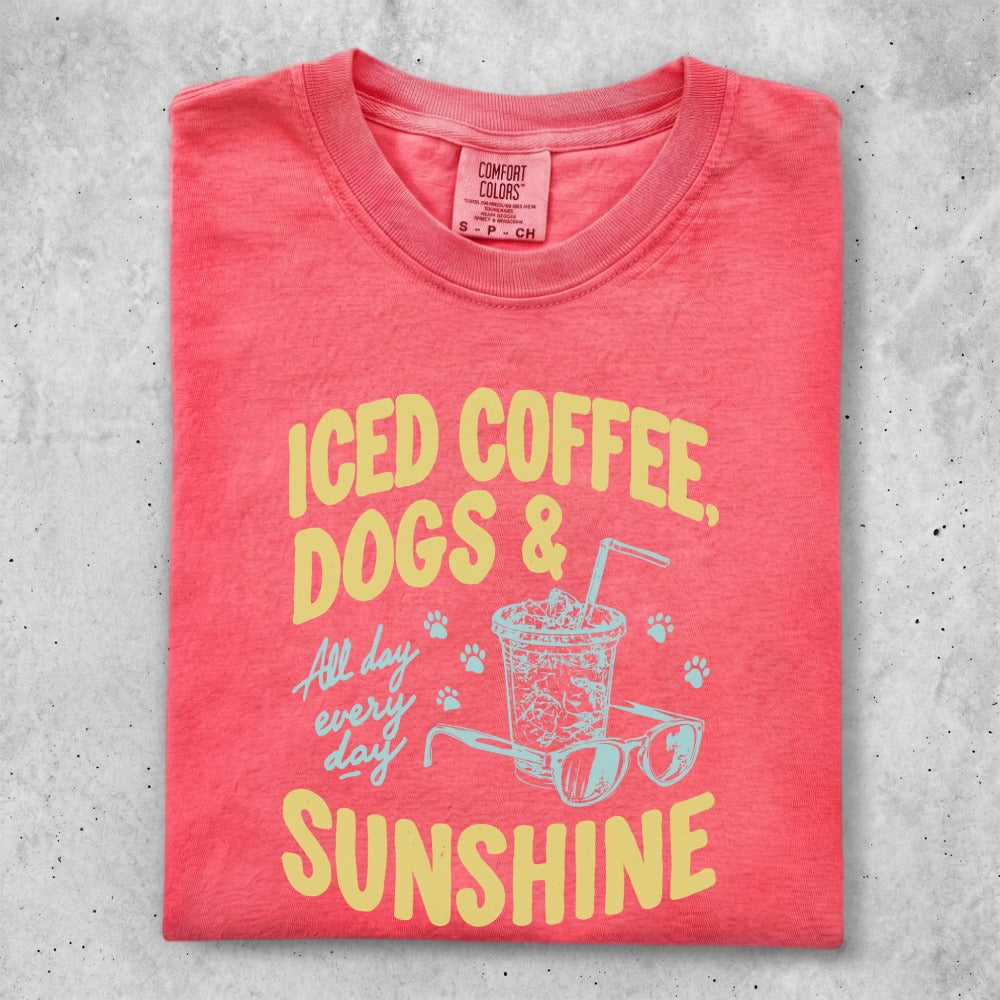 Coral t-shirt with "Iced coffee, dogs & sunshine" text and a drink.