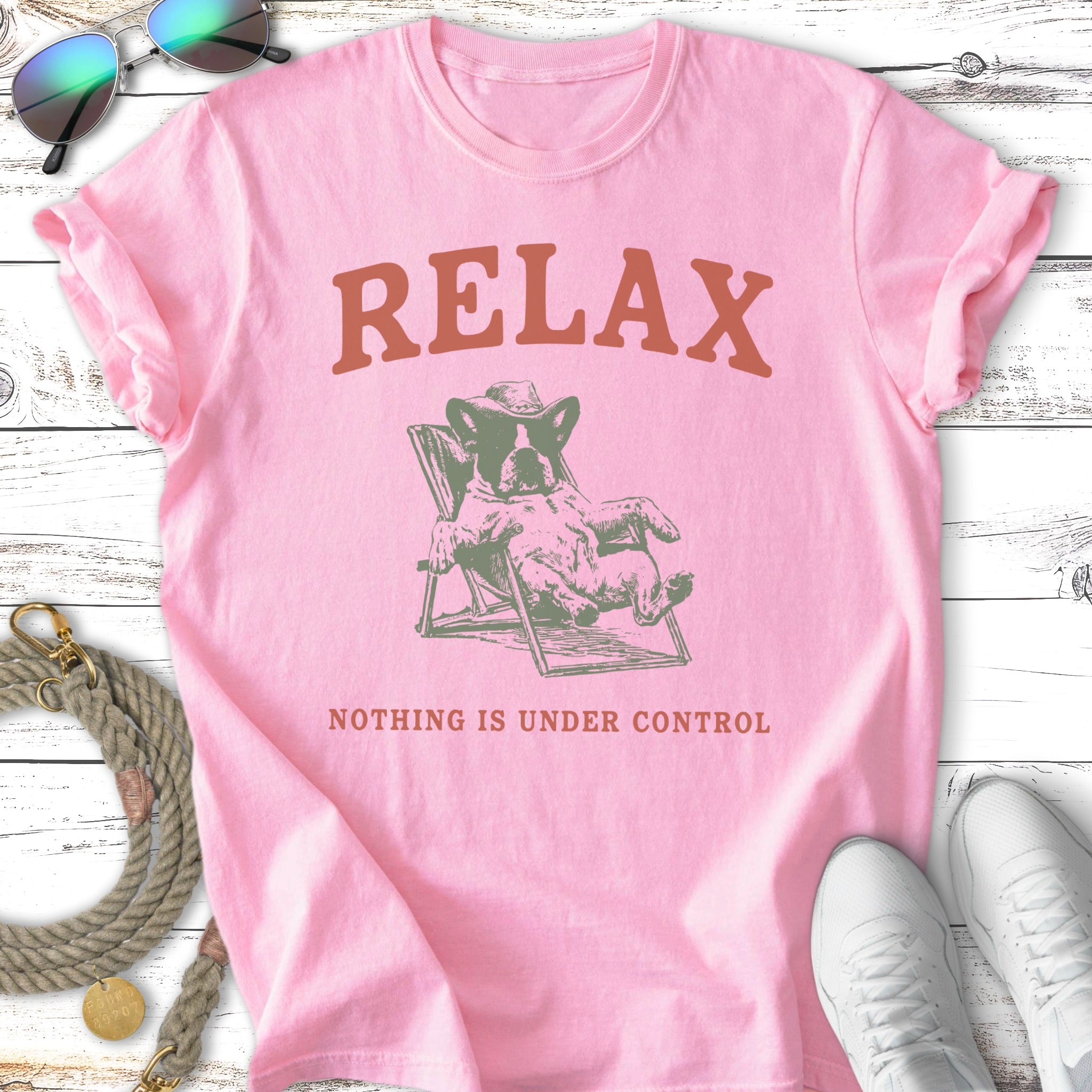 Pink t-shirt with French bulldog in beach chair, "RELAX NOTHING IS UNDER CONTROL" text.