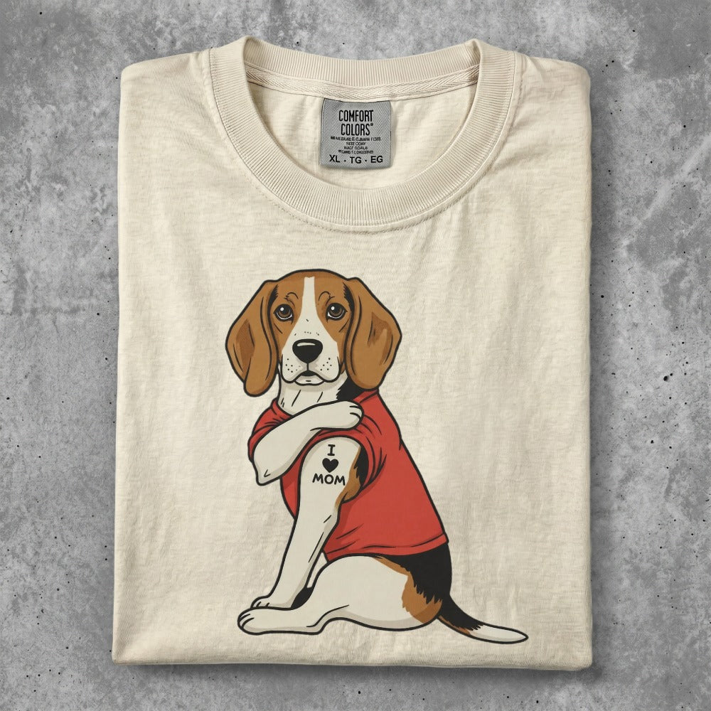 Beagle wearing red shirt with "I Love Mom" tattoo on arm.