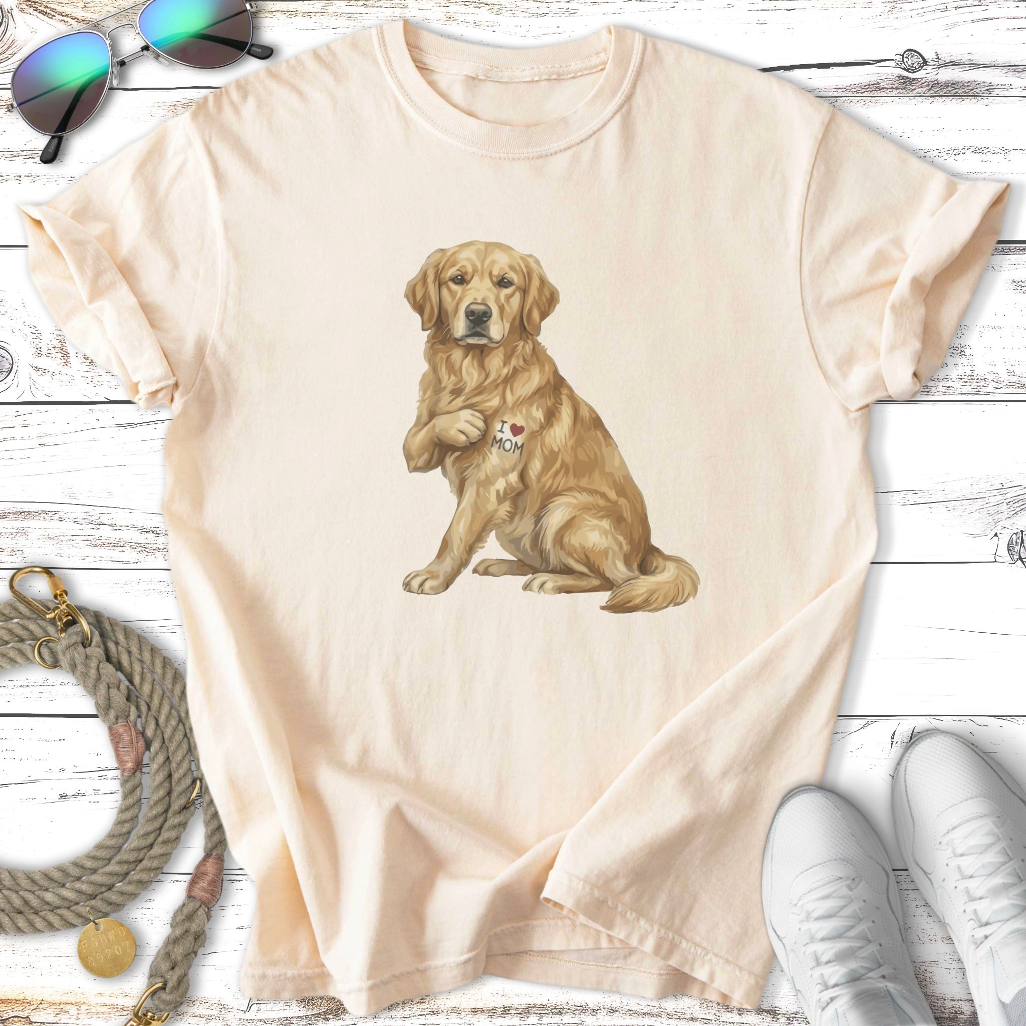 Golden retriever wearing a shirt with "I ❤️ MOM" on it.