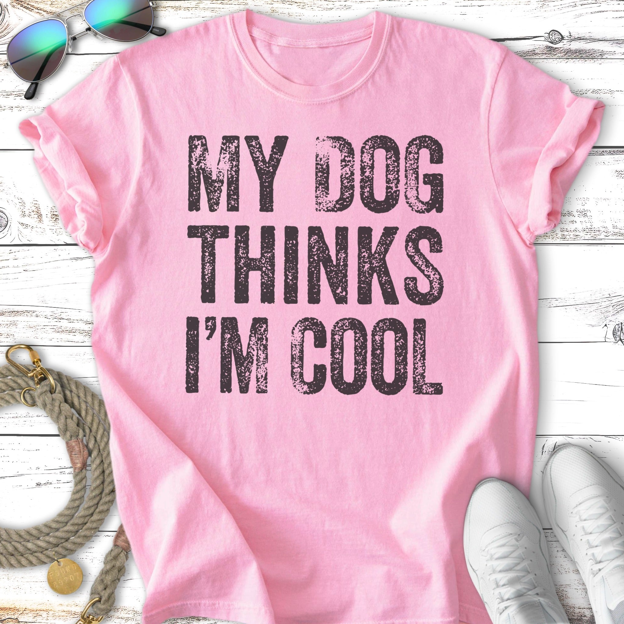 Pink t-shirt with black text: "MY DOG THINKS I'M COOL".