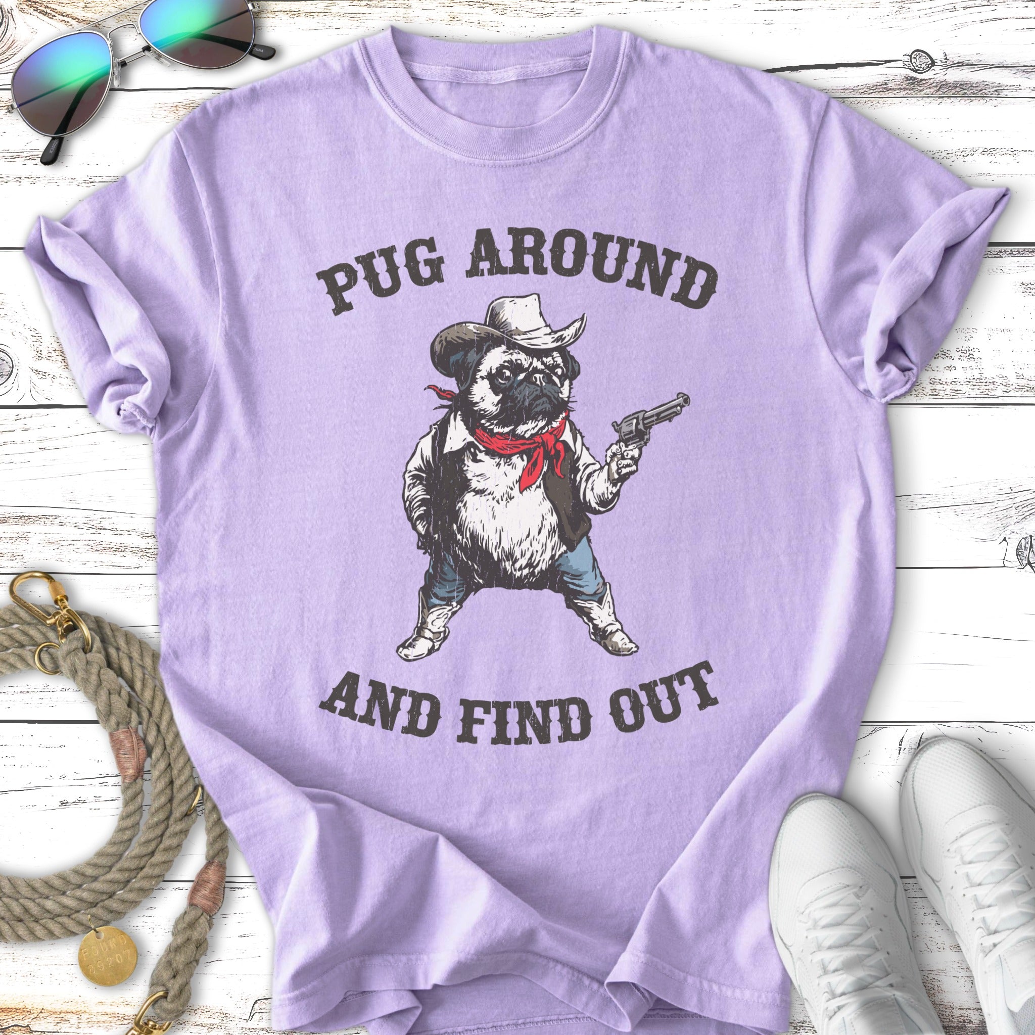Pug wearing cowboy hat and bandana, holding a gun, text "Pug Around and Find Out".