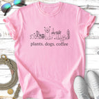 Pink t-shirt with a sketch of a dog, plants, and the text "plants. dogs. coffee."
