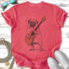 Pug playing an electric guitar, sketched illustration on a coral t-shirt.