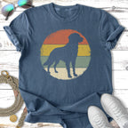 Distressed graphic of a dog silhouette on a retro sunset background.