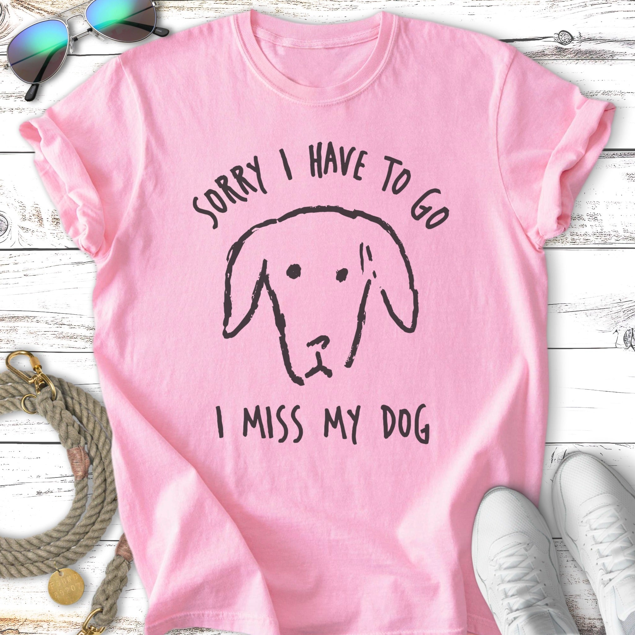 Pink t-shirt with "Sorry I Have To Go, I Miss My Dog" and a dog drawing.