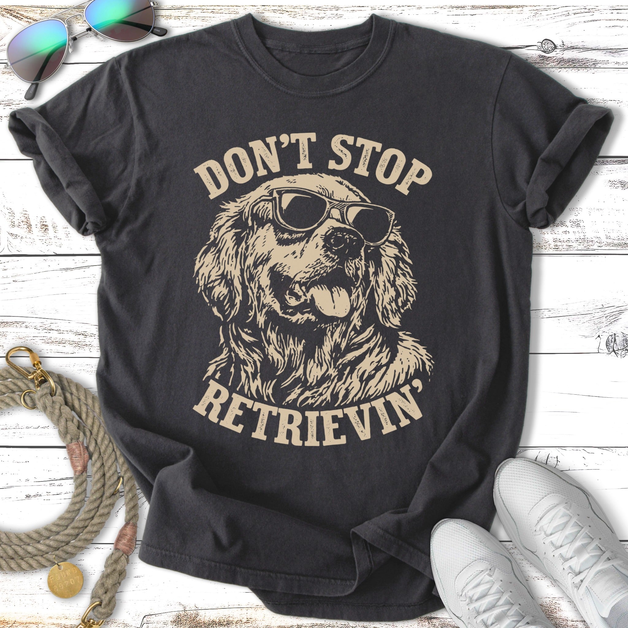 Dark t-shirt with "Don't Stop Retrieving" text and a Golden Retriever wearing sunglasses.
